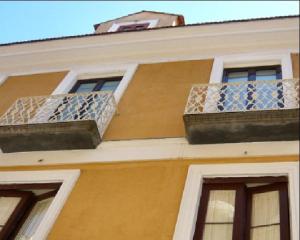a building with two balconies on the side of it at DolceVitaSorrento Guest House in Sorrento