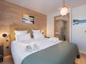 a bedroom with a large white bed with towels on it at Appartement Courchevel 1650, 5 pièces, 8 personnes - FR-1-563-136 in Courchevel
