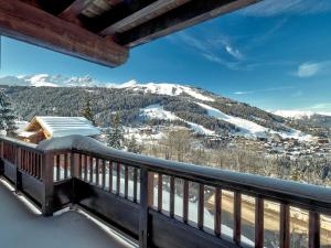 a balcony with a view of a snowy mountain at Appartement Courchevel 1650, 5 pièces, 8 personnes - FR-1-563-136 in Courchevel