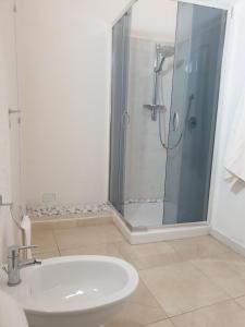 a bathroom with a shower and a toilet and a sink at I SICANI HOUSE AND MORE in Catania