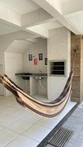a hammock in a room in a building at Recanto Vó Mônica in Palhoça