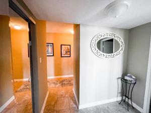 a hallway with a mirror on the wall at Playing Hooky at Dolphin Run-Oceanfront Condo-Pool in Virginia Beach +44 photos
