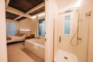 a bathroom with a shower and a bath tub at Casa Pelegrí in Morella