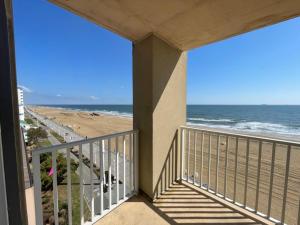 a balcony with a view of the beach at Playing Hooky at Dolphin Run-Oceanfront Condo-Pool in Virginia Beach