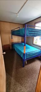 a bunk bed room with two bunk beds in it at Cabaña Puerto Williams in Puerto Williams