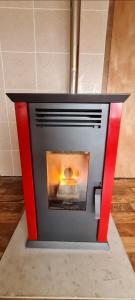 a fireplace with a red frame in a room at Cabaña Puerto Williams in Puerto Williams