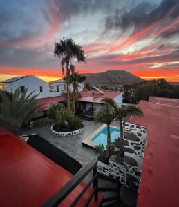 a view of a house with a pool and palm trees at Casa Cocolores in Villaverde