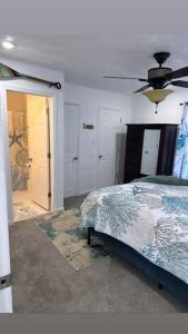 a bedroom with a bed and a ceiling fan at Ocean Haus in Portsmouth