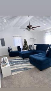 a living room with blue couches and a christmas tree at Ocean Haus in Portsmouth