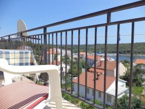 - Balcón con silla y vistas al agua en Ferienwohnung mit Balkon für vier Personen, en Pula