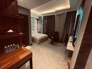 a hotel room with a bed and a desk at The Capital Heart Hotel in Baghdād +15 photos