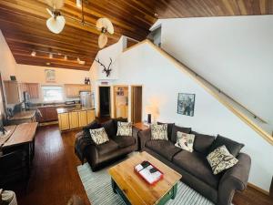 a living room with a couch and a table at 100 Steps Away Ski in Ski Out Condo in Big Sky