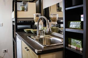 a kitchen with a sink and a shelf at B&B Gelso Rosso Pompei in Pompei +47 photos