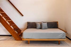 a bed in a room next to a staircase at Body - Tiny Home Venao Cove in Playa Venao