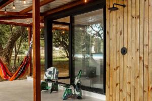 a house with sliding glass doors and a hammock at Body - Tiny Home Venao Cove in Playa Venao