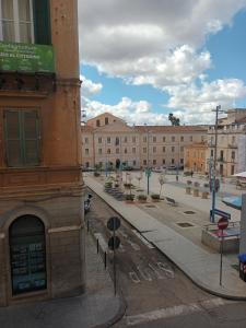an empty street in a city with buildings at B&B Le Finestre Su Via Cavour in Sassari