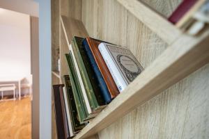 a row of books on a book shelf at Zaciszny Zakątek by Rentoom in Toruń +11 photos
