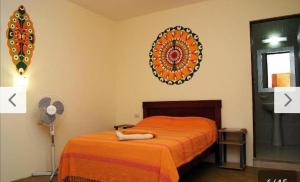 a bedroom with a bed and a mirror on the wall at AquamarInn in Máncora