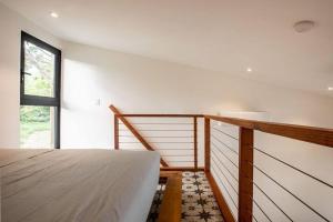 a bedroom with a bed and a window at Mind- Tiny Home Venao Cove in Playa Venao