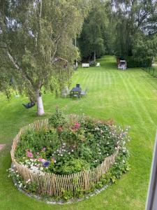 a garden with a flower bed in the grass at Landhaus Oscar (150m zum Strand) in Westerholz