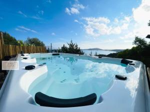 a hot tub with a view of the water at Castelletto Beach in Villasimius