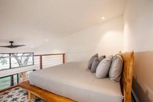 a bedroom with a bed with pillows on it at Soul - Tiny Home Venao Cove in Playa Venao
