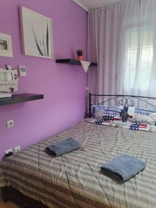 a bedroom with a bed with two pillows on it at Artemis in Thessaloniki