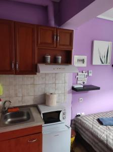 a small kitchen with a sink and a stove at Artemis in Thessaloniki