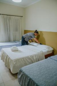 a man jumping between two beds in a room at Alma Mendoza Hotel in Mendoza