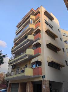 a tall building with balconies on the side of it at Artemis in Thessaloniki