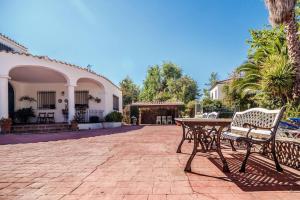 Un patio con una mesa y sillas frente a un edificio. en La Veguilla Úbeda, en Úbeda