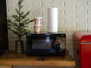 a microwave sitting on a table with a christmas tree at Stonegate Lodge - Pool & Firepits Room #208 in Eureka Springs
