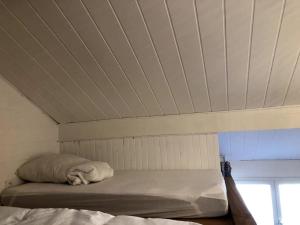 a bed in a room with a white ceiling at Studio cinéma in Alès