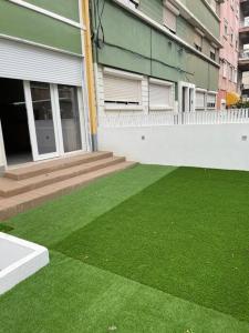 a yard with green grass in front of a building at Lovely 2 bedroom apartment in South Lisbon in Barreiro