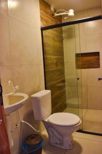 a bathroom with a toilet and a sink and a shower at Caminho do Paraíso in Porto De Galinhas