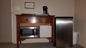 a microwave on a table next to a refrigerator at Ronnie's Resort in Payson