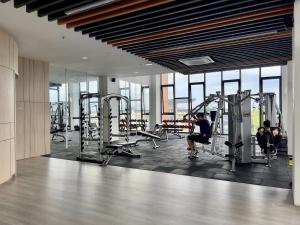 a gym with people exercising on tread machines in a building at Hush Inn at K Avenue Kota Kinabalu in Kota Kinabalu
