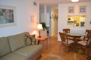a living room with a couch and a table at Beautiful Downtown Truman Annex Condo in Key West