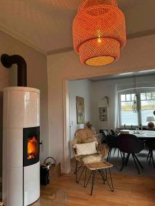 a living room with a fireplace and a dining room at Landhaus Oscar (150m zum Strand) in Westerholz