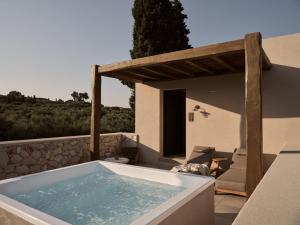 a jacuzzi tub on the patio of a house at Pierros Verde in Lithakia