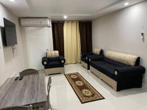 a living room with a couch and a table at Condo with pool in Portmore in Portmore