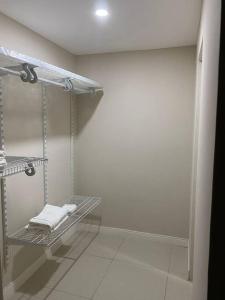 a bathroom with a towel rack in a room at Condo with pool in Portmore in Portmore