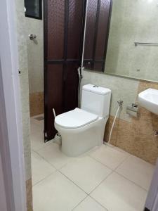 a bathroom with a toilet and a sink at Serena Casa in Mobor Goa