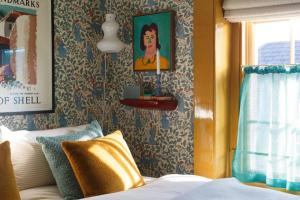a bedroom with a bed and a wall with wallpaper at Suites @ The Townhouse by designer Tobias Vernon in Bath