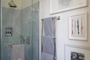 a shower with a glass door in a bathroom at Suites @ The Townhouse by designer Tobias Vernon in Bath