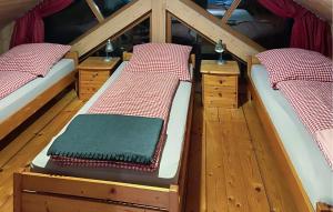 two bunk beds in a room with wooden floors at 2 Bedroom Amazing Home In Wartmannsroth in Wartmannsroth