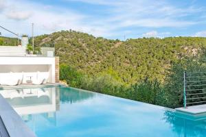 a swimming pool with a view of a mountain at Costa d'en Blanes villa SeA ViEw in Costa d'en Blanes