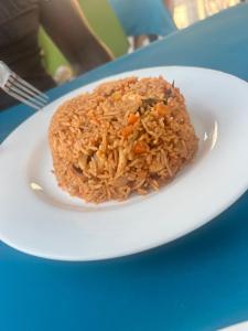 a plate of rice and carrots on a table at Bojang River Lodge in Bakau