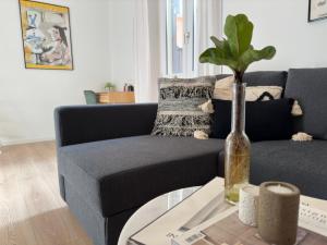 uma sala de estar com um sofá e uma mesa com um vaso em Home Sweet Orti 12 - Design Apartment em Milão