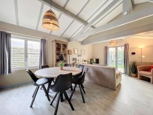 a living room with a table and chairs and a couch at Pur Sea vakantiehuis te Middelkerke / Westende in Middelkerke
